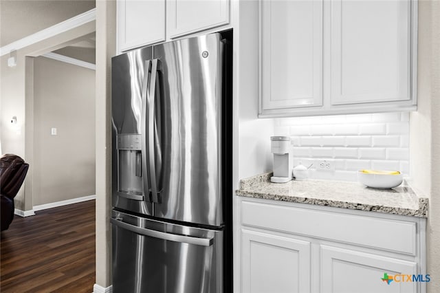 kitchen with white cabinets, stainless steel fridge, dark hardwood / wood-style flooring, and light stone countertops