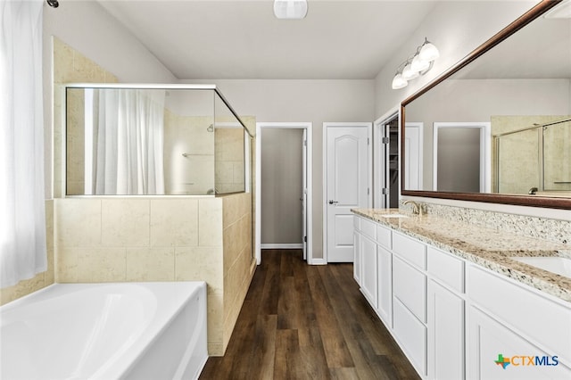 bathroom featuring hardwood / wood-style floors, vanity, and independent shower and bath