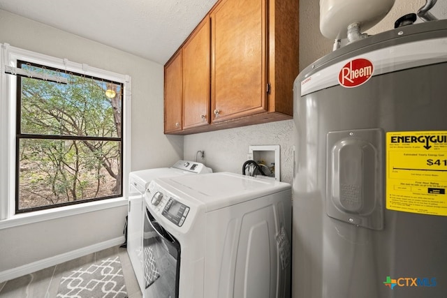 laundry room with independent washer and dryer, cabinets, electric water heater, and a textured ceiling