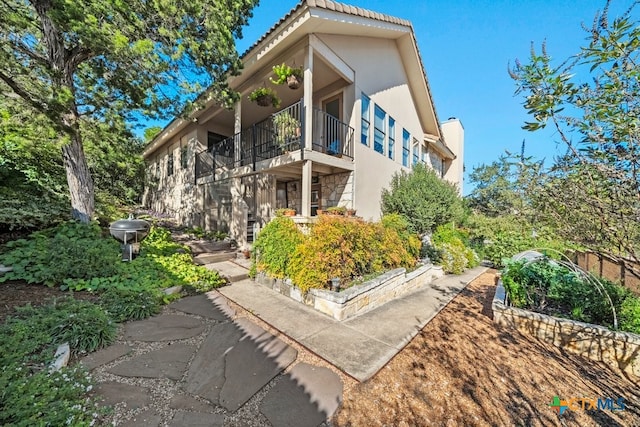 back of property featuring a balcony