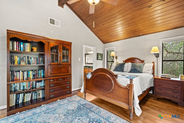 bedroom with ensuite bath, wood ceiling, ceiling fan, hardwood / wood-style floors, and vaulted ceiling with beams