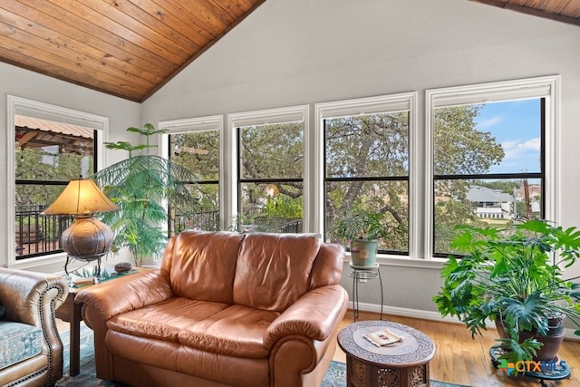 sunroom / solarium with a healthy amount of sunlight, lofted ceiling, and wooden ceiling