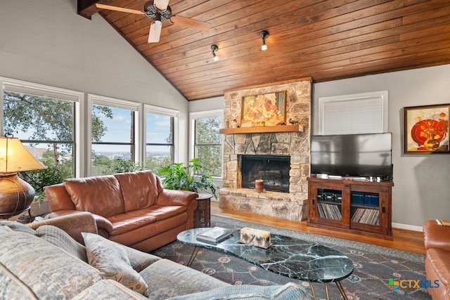 living room with ceiling fan, vaulted ceiling with beams, a fireplace, wood ceiling, and hardwood / wood-style flooring