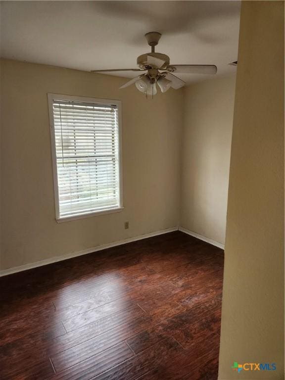 unfurnished room featuring ceiling fan and dark hardwood / wood-style flooring