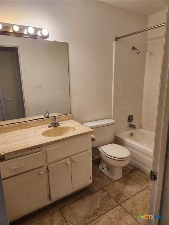 full bathroom featuring tiled shower / bath combo, vanity, and toilet