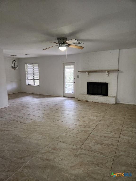 unfurnished living room with a brick fireplace, light tile patterned flooring, and ceiling fan