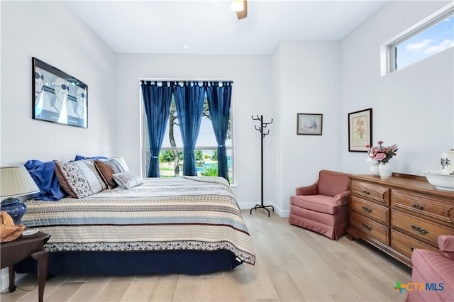 bedroom with light hardwood / wood-style floors and ceiling fan