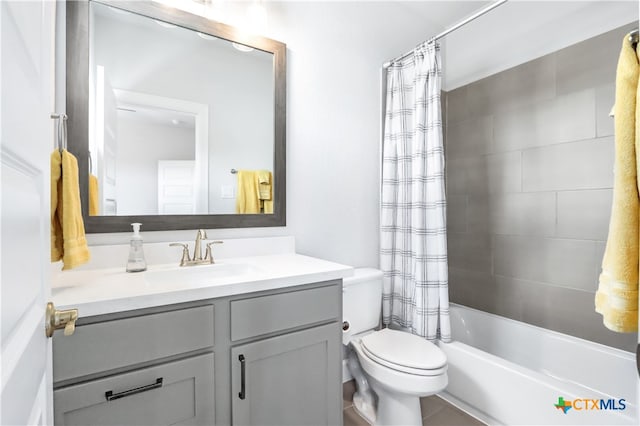 full bathroom featuring vanity, shower / bath combination with curtain, and toilet