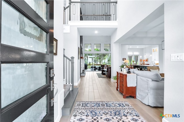 foyer entrance with a towering ceiling