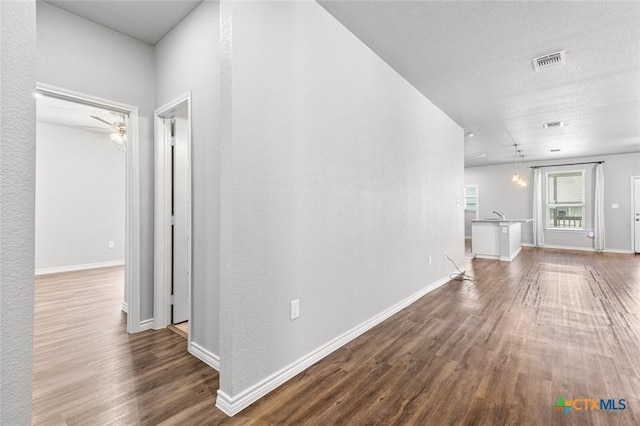 7917 Purvis St, Temple, TX 76502 - corridor featuring dark wood-style flooring and baseboards
