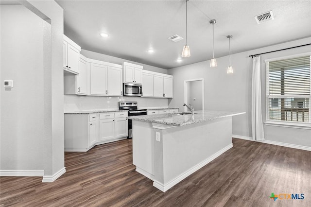 7917 Purvis St, Temple, TX 76502 - kitchen featuring appliances with stainless steel finishes, dark wood-style floors, white cabinets, and recessed lighting