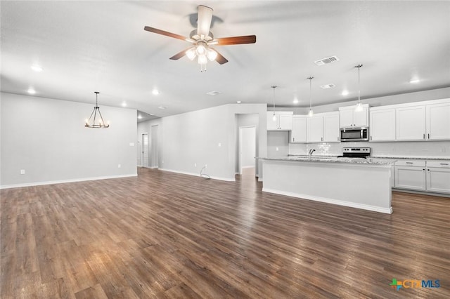 7917 Purvis St, Temple, TX 76502 - unfurnished living room featuring recessed lighting, dark wood-style flooring, ceiling fan, and a chandelier