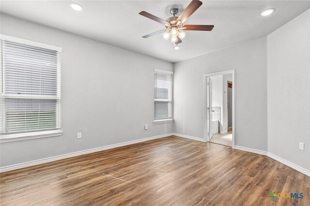 7917 Purvis St, Temple, TX 76502 - unfurnished bedroom featuring wood finished floors, recessed lighting, ceiling fan, and connected bathroom