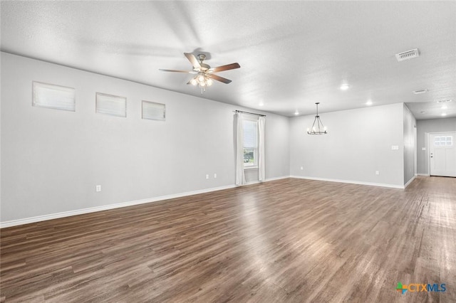 7917 Purvis St, Temple, TX 76502 - unfurnished living room with ceiling fan, wood finished floors, a chandelier, recessed lighting, and a textured ceiling