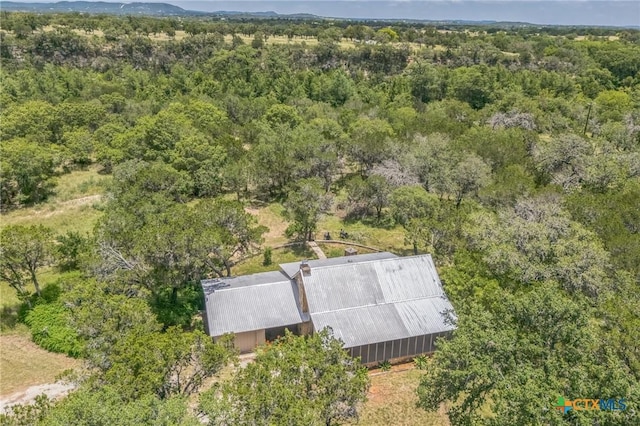 959 Highland Dr, Bandera, TX 78003 - aerial view of property and surrounding area featuring a heavily wooded area