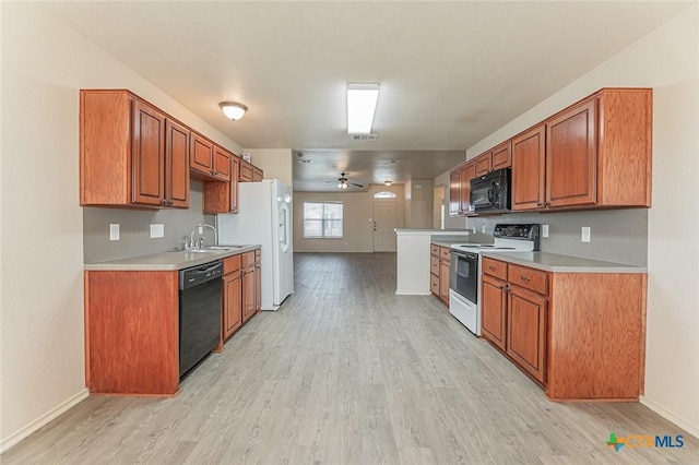 kitchen with ceiling fan, sink, light hardwood / wood-style flooring, and black appliances