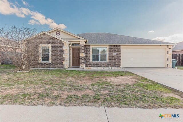 ranch-style house with a garage and a front lawn