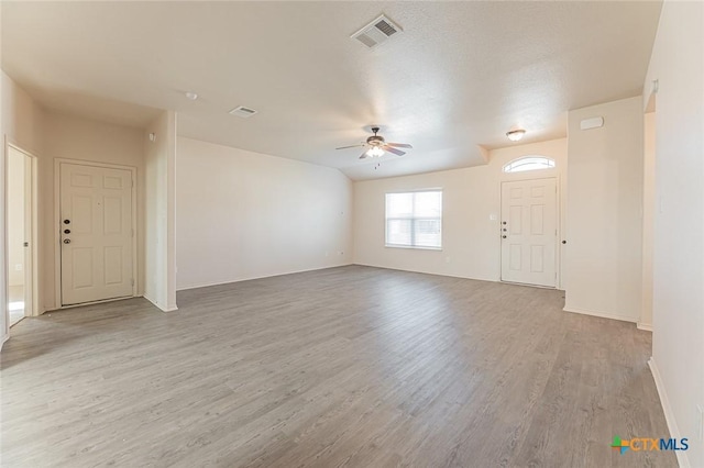 unfurnished living room featuring ceiling fan and light hardwood / wood-style floors