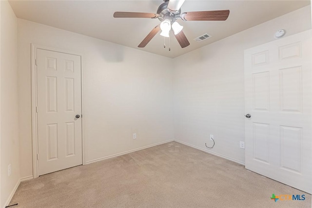 carpeted spare room with ceiling fan