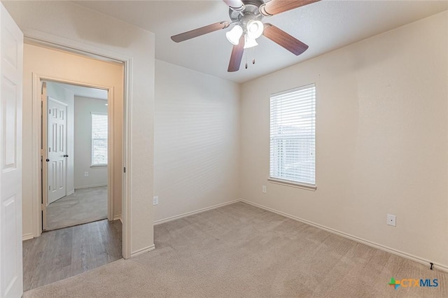 unfurnished room featuring ceiling fan and light colored carpet