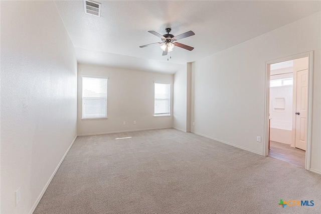 spare room with light carpet, a textured ceiling, and ceiling fan