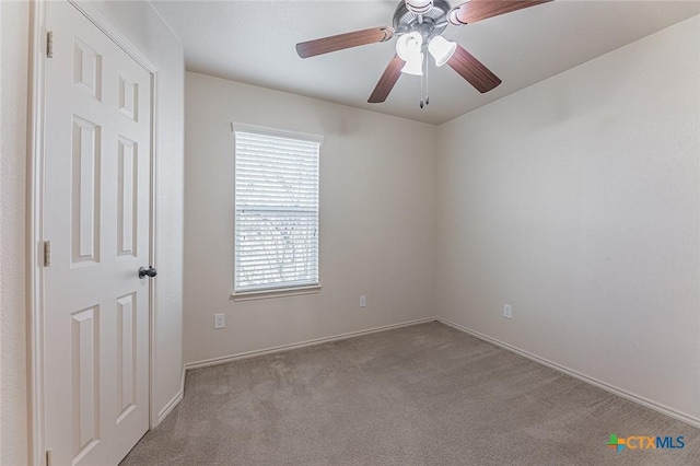 unfurnished room with ceiling fan and light colored carpet