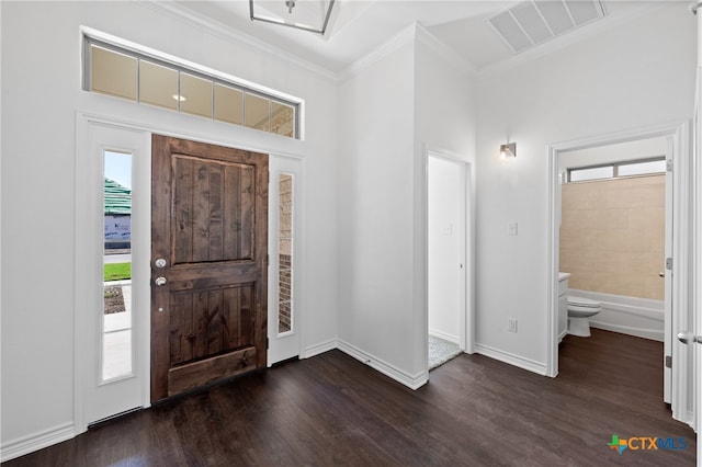 foyer entrance featuring dark wood-type flooring and ornamental molding