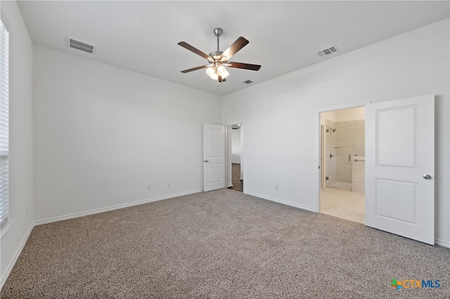 unfurnished bedroom with connected bathroom, light colored carpet, and ceiling fan