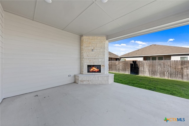 view of patio featuring an outdoor stone fireplace