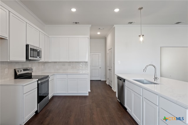 kitchen featuring sink, dark hardwood / wood-style floors, decorative light fixtures, white cabinets, and appliances with stainless steel finishes