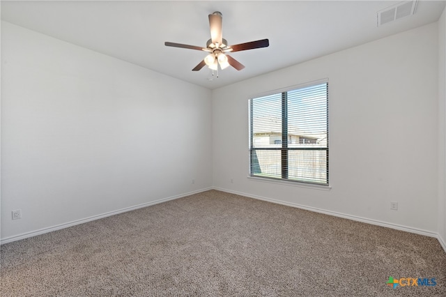 carpeted spare room featuring ceiling fan