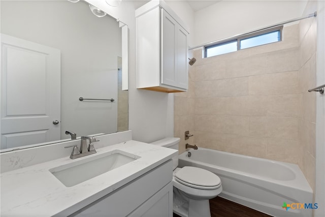 full bathroom with vanity, toilet, and tiled shower / bath