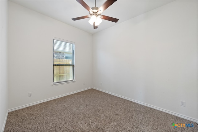 empty room featuring ceiling fan and carpet