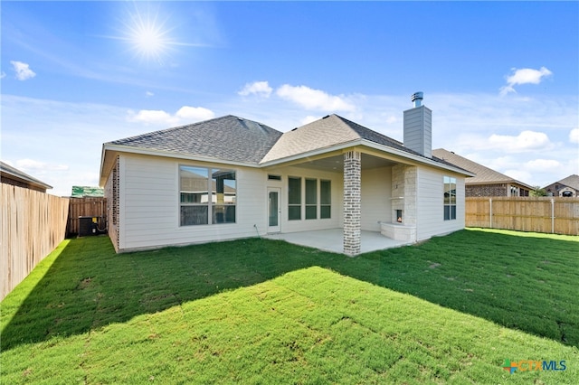 back of house with a yard, cooling unit, and a patio