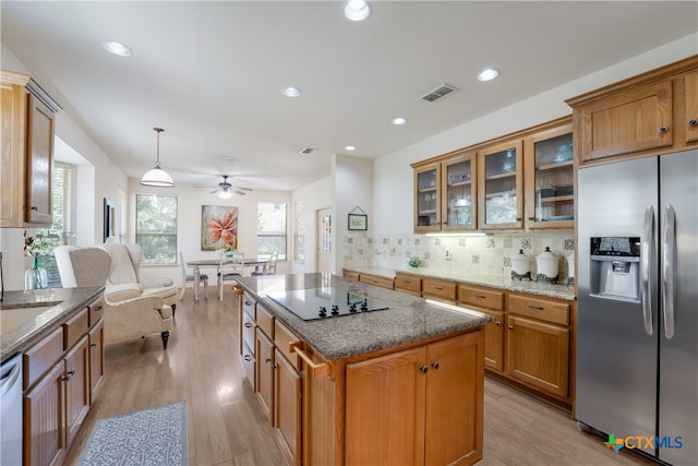 1763 Oak Gln, New Braunfels, TX 78132 - kitchen featuring stainless steel refrigerator with ice dispenser, black electric stovetop, light wood-style flooring, stone countertops, and recessed lighting