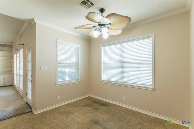 tiled spare room with built in features, a ceiling fan, baseboards, visible vents, and crown molding