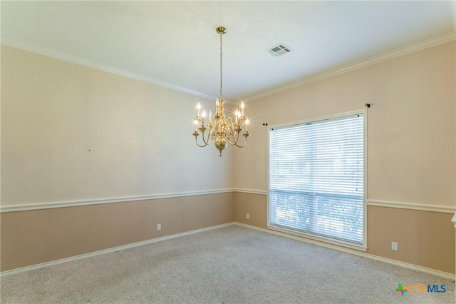carpeted spare room featuring visible vents, baseboards, a notable chandelier, and crown molding
