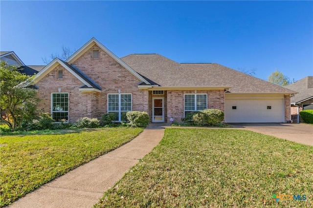 view of front of home with a garage, brick siding, concrete driveway, and a front yard