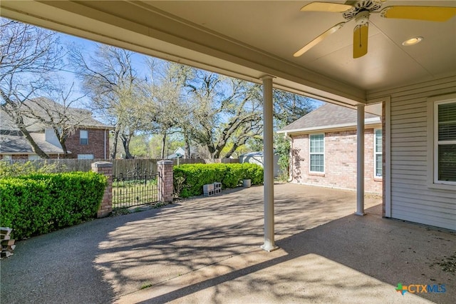 view of patio with a gate, ceiling fan, and fence