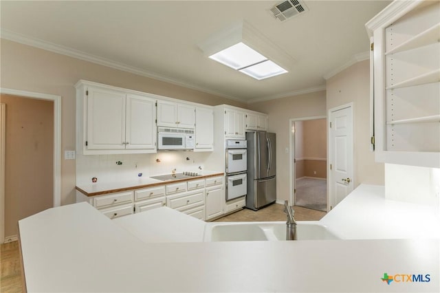 kitchen featuring white cabinetry, white appliances, visible vents, and open shelves