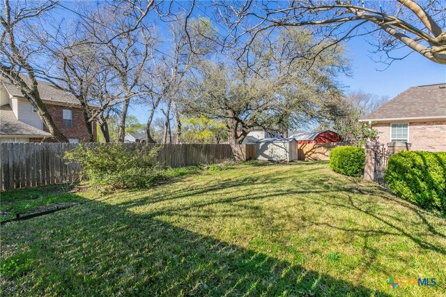 view of yard featuring an outbuilding and a fenced backyard