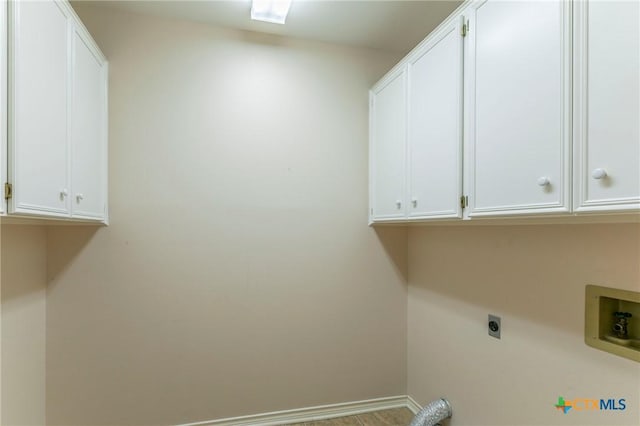 washroom with electric dryer hookup, baseboards, cabinet space, and washer hookup