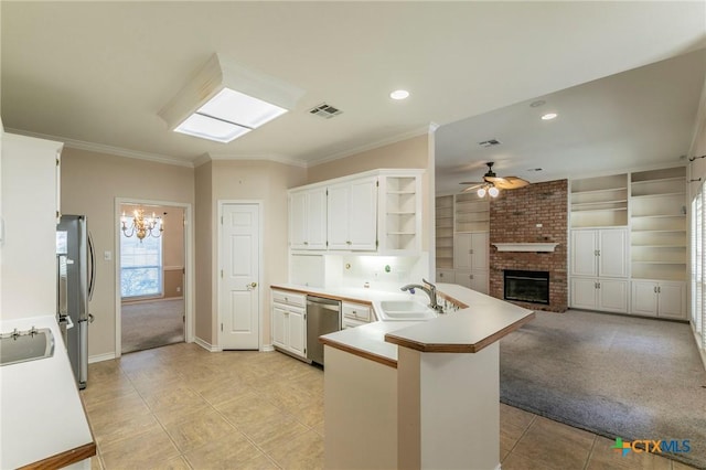 kitchen with light carpet, ceiling fan with notable chandelier, open shelves, appliances with stainless steel finishes, and a peninsula