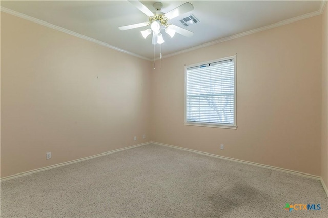 spare room with visible vents, baseboards, a ceiling fan, and crown molding