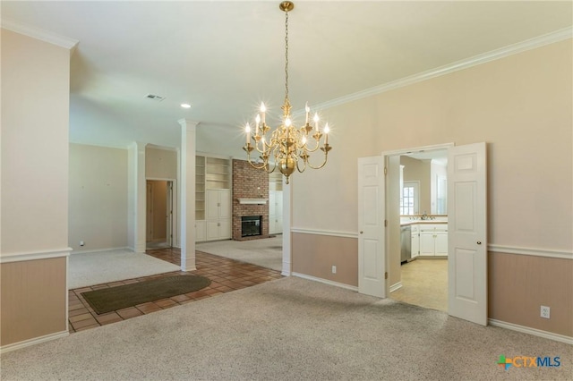 unfurnished dining area with built in features, visible vents, light carpet, and ornamental molding