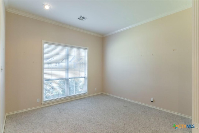 carpeted empty room featuring visible vents, crown molding, and baseboards