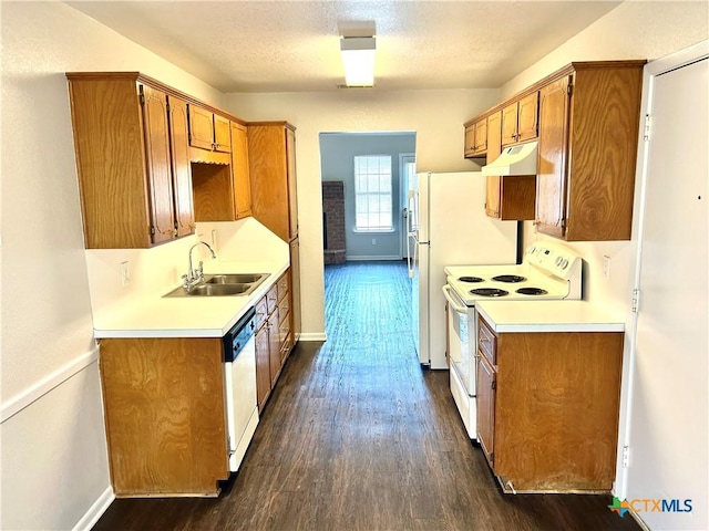 kitchen featuring a textured ceiling, dark hardwood / wood-style flooring, white appliances, and sink