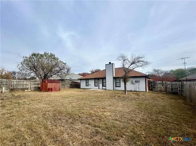 rear view of property with a lawn