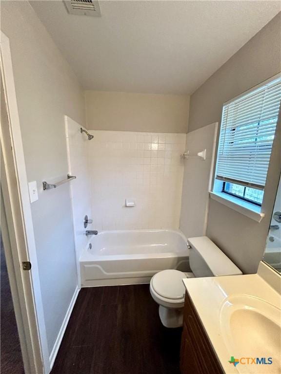 full bathroom featuring vanity, toilet, wood-type flooring, and tiled shower / bath