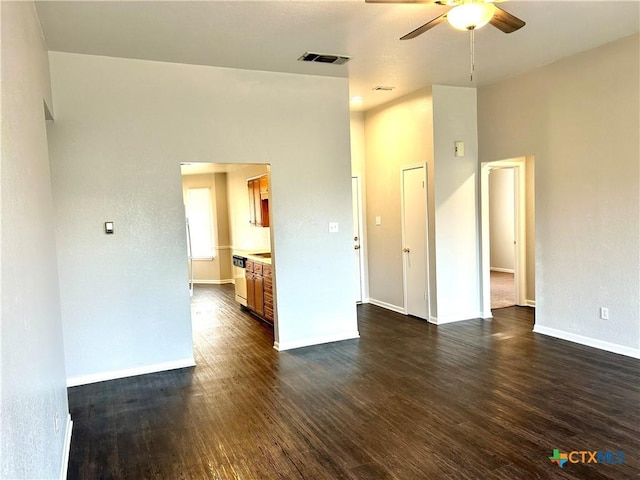 unfurnished room featuring ceiling fan and dark wood-type flooring